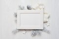 Mockup Christmas greeting card top view and white frame, flatlay on a white wooden background with a ribbon, with place