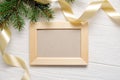 Mockup Christmas greeting card top view and wood frame, flatlay on a white wooden background with a ribbon, with place Royalty Free Stock Photo