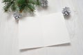 Mockup Christmas greeting card with tree branch, flatlay on a white wooden background, with place for your text Royalty Free Stock Photo