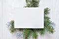 Mockup Christmas greeting card with tree and cone, flatlay on a white wooden background, with place for your text Royalty Free Stock Photo