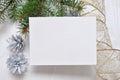 Mockup Christmas greeting card with tree and gold gift ribbon, flatlay on a white wooden background, with place for your Royalty Free Stock Photo