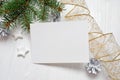 Mockup Christmas greeting card with tree and gold gift ribbon, flatlay on a white wooden background, with place for your Royalty Free Stock Photo