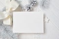 Mockup Christmas greeting card with white tree and cone, flatlay on a white wooden background, with place for your text