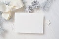 Mockup Christmas greeting card with white tree and cone, flatlay on a white wooden background, with place for your text Royalty Free Stock Photo