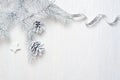 Mockup Christmas tree cone and silver ribbon, flatlay on a white wooden background, with place for your text Royalty Free Stock Photo