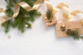 Mockup Christmas white tree, beige bow, gold gift box and cone. Flat lay on a white wooden background, with place for Royalty Free Stock Photo