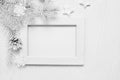 Mockup Christmas white tree wooden frame with place for your text, decorative stars, snowflakes and cone. Flat lay on a white wood Royalty Free Stock Photo