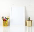 Mockup with clean white frame, colored pencils and succulent on white background. Concept for creativity, drawing. Royalty Free Stock Photo