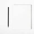 Mockup of closed blank square book and black pencil at white textured paper background Royalty Free Stock Photo