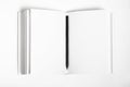 Mockup of closed blank square book and black pencil at white textured paper background Royalty Free Stock Photo