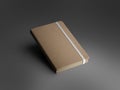 Mockup of closed craft notebook with white band, textured hard cover, brown pages, isolated with shadows on gray background Royalty Free Stock Photo