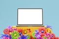 Mockup copy space in laptop on a stand with flowers on blue background Royalty Free Stock Photo