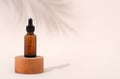 Mockup cosmetic face serum brown glass bottle with a pipette on a stylish minimalist