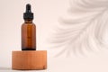 Mockup cosmetic face serum brown glass bottle with a pipette on a stylish minimalist