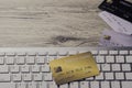 mockup credit card above white tablet keyboard on an office wooden table