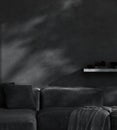 Mockup dark living room wall mockup, gray plaster wall, black stylish sofa, 3d render