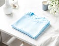 Simple T-Shirt Mockup Folded Light Blue Shirt on White Background Royalty Free Stock Photo