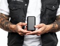 Portable Device in Hands of Tattooed Person Perfect for Tech and Lifestyle Blogs Royalty Free Stock Photo