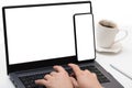 Mockup device. female hands typing on laptop keyboard with blank white screen, cell phone and laptop use at same time Royalty Free Stock Photo