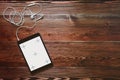 Digital tablet computeron old wooden desk. Royalty Free Stock Photo