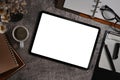 Mockup digital tablet, flower pot, notebook, coffee cup and glasses on stone background. Top view