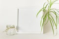 Mockup with empty blank picture frame, glass jar and plant Royalty Free Stock Photo