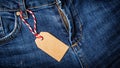 Mock up of empty brown paper price tag on blue jeans Royalty Free Stock Photo