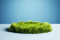 mockup of empty Grass podium, on a blue background. Grass circle, copy space. Royalty Free Stock Photo