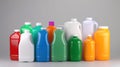 Mockup of empty multi-colored bottles in a row of household chemicals on a plain black background. Royalty Free Stock Photo