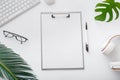 Mockup empty notes list on workspace on white office table desk. Home freelance work space with keyboard mouse glasses Royalty Free Stock Photo