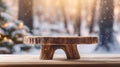 Mockup of empty wooden display, log product stand with blurred snow forest in morning sunlight, peaceful winter background. Royalty Free Stock Photo