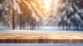 Mockup of empty wooden display product stand, table with blurred snow pine trees forest in morning sunlight, peaceful winter Royalty Free Stock Photo