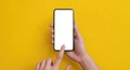Mockup of female hand holding cell phone with blank screen. Mobile phone with blank white screen on yellow background. Gadget with Royalty Free Stock Photo