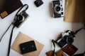 Mockup with film retro cameras on a white table