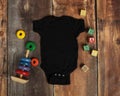 Mockup Flat Lay Of Black Baby Bodysuit Shirt
