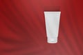 Mockup foam facial cleanser in white is displayed on a red background for advertising purposes, 3D rendering