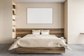 Mockup frame in beige bedroom with bed, beige linens and bookshelf on grey floor Royalty Free Stock Photo