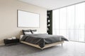 Mockup frame in beige bedroom, grey bed with linens near window Royalty Free Stock Photo