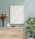 Mockup frame on cabinet in living room interior on empty dark blue wall background Royalty Free Stock Photo