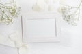 Mockup frame with flowers and bow greeting card for Valentines Day or wedding with place for your text. Flat lay, top