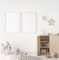 Mockup frame in minimal unisex child bedroom with natural wooden furniture Royalty Free Stock Photo