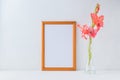 Mockup golden frame and pink flowers