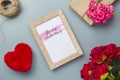 Mockup golden picture frame for Valentines day concept. Top view of mock up photo frame with rose flowers, craft roses, handy Royalty Free Stock Photo