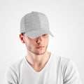 Mockup of gray heather baseball cap on a man`s head, isolated on background, front view