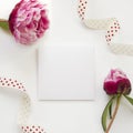 Greeting card template decorated by peony flowers and polka-dot ribbon Royalty Free Stock Photo