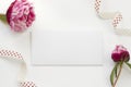 Greeting card template decorated by peony flowers and polka-dot ribbon Royalty Free Stock Photo