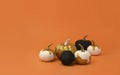 Mockup Halloween creative stilllife. Golden and black pumpkins on orange background. Seasonal greeting card for fall, Thanksgiving Royalty Free Stock Photo