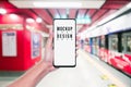 Mockup of hand using mobile phone with copy space blank screen for your advertisement with blurred view of red subway, internet Royalty Free Stock Photo