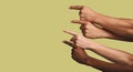Mockup, hands and group of people in studio with answer, gesture or sign against yellow background. Finger, direction
