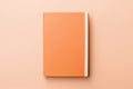 Mockup of hardcover notebook notepad with blank cover on peach fuzz minimal background. Modern trendy tone hue shade